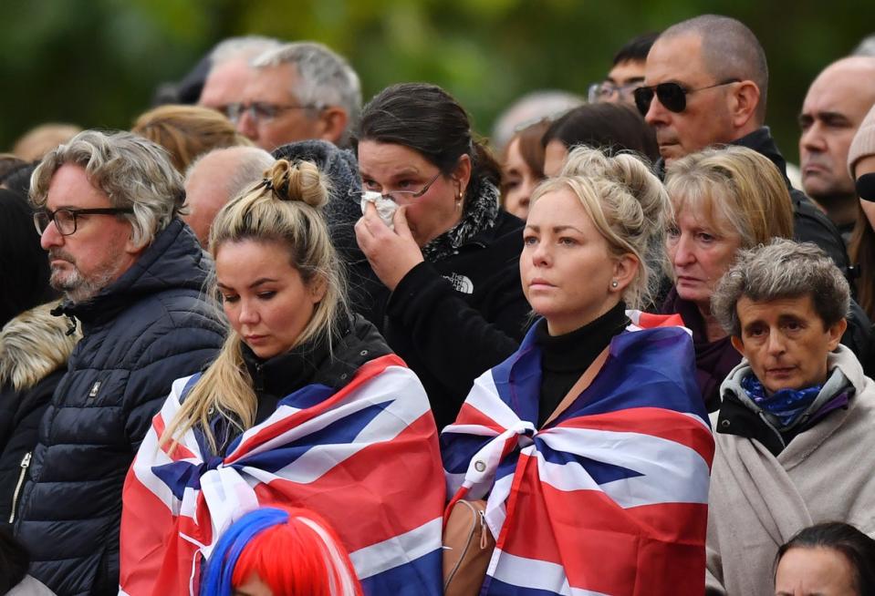 Mourners on the Mall listening to the state funeral (PA)