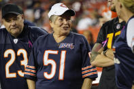 Julie Robison, from Jacksonville, Fla, wearing Dick Butkus Chicago Bears #51 jersey before starting an NFL football game against the Washington Commanders on Thursday, Oct. 5, 2023, in Landover, Md. Butkus, the fearsome middle linebacker for the Bears, has died, the team announced Thursday. (AP Photo/Alex Brandon)