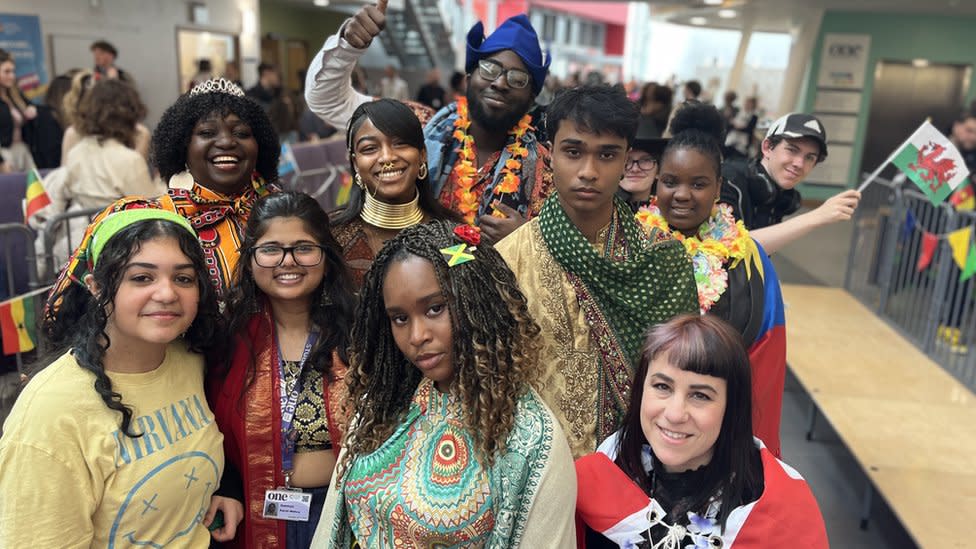A crowd of young people in colourful outfits from Asia, Africa and Europe