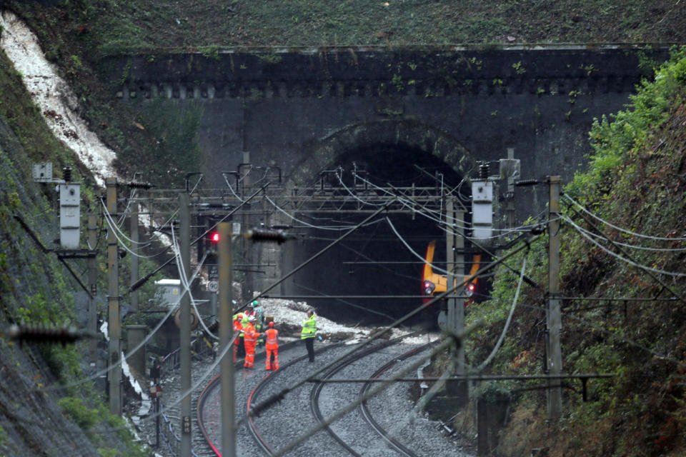 Water which caused a landslip and train derailment gushes down embankment (SWNS)