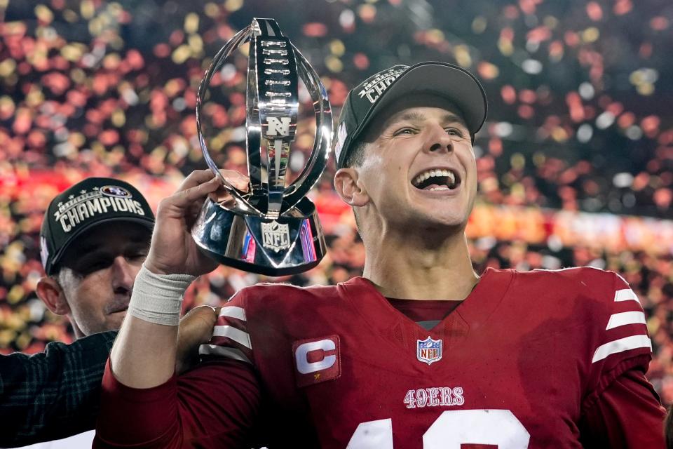 San Francisco 49ers quarterback Brock Purdy celebrates with the trophy after their win against the Detroit Lions in the NFC Championship game on Sunday. Purdy played college football at Iowa State.