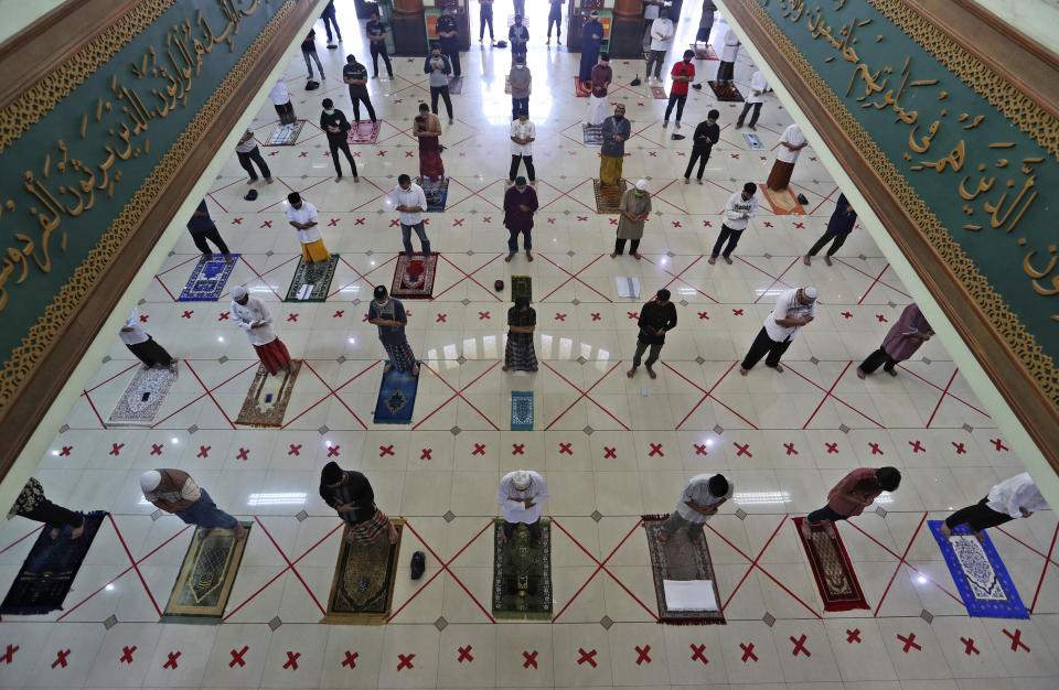 Muslims pray spaced apart to help curb the spread of the coronavirus during a Friday prayer at the Al Barkah Grand Mosque in Bekasi on the outskirts of Jakarta, Indonesia, Friday, May 29, 2020. Muslims in some parts of Indonesia attended Friday prayers as mosques closed by the coronavirus for weeks were allowed to start reopening in the world's most populous Muslim nation. (AP Photo/Achmad Ibrahim)