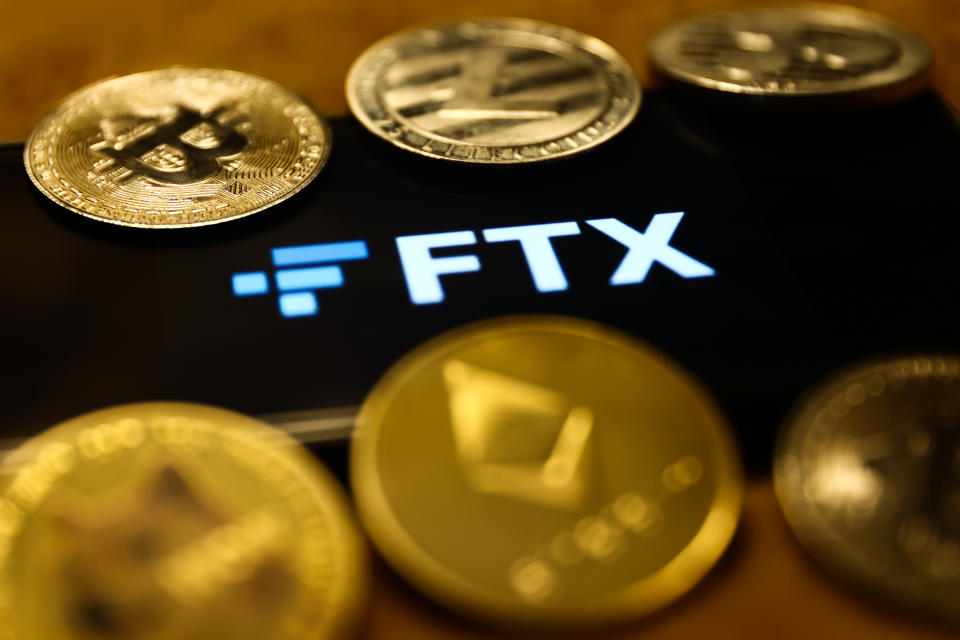 FTX logo displayed on a phone screen and representation of cryptocurrencies are seen in this illustration photo taken in Krakow, Poland on January 29, 2023. (Photo by Jakub Porzycki/NurPhoto via Getty Images)