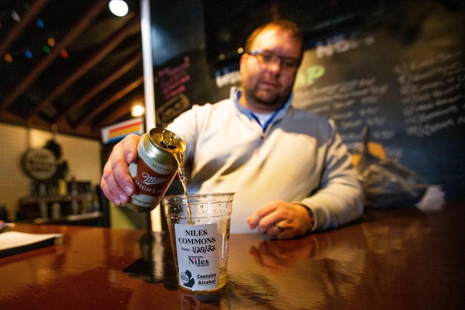 Brandon Townsley pours a beer into a labeled cup Thursday, Jan. 27, 2022 at Niles Brewing Company in Niles, Michigan. 