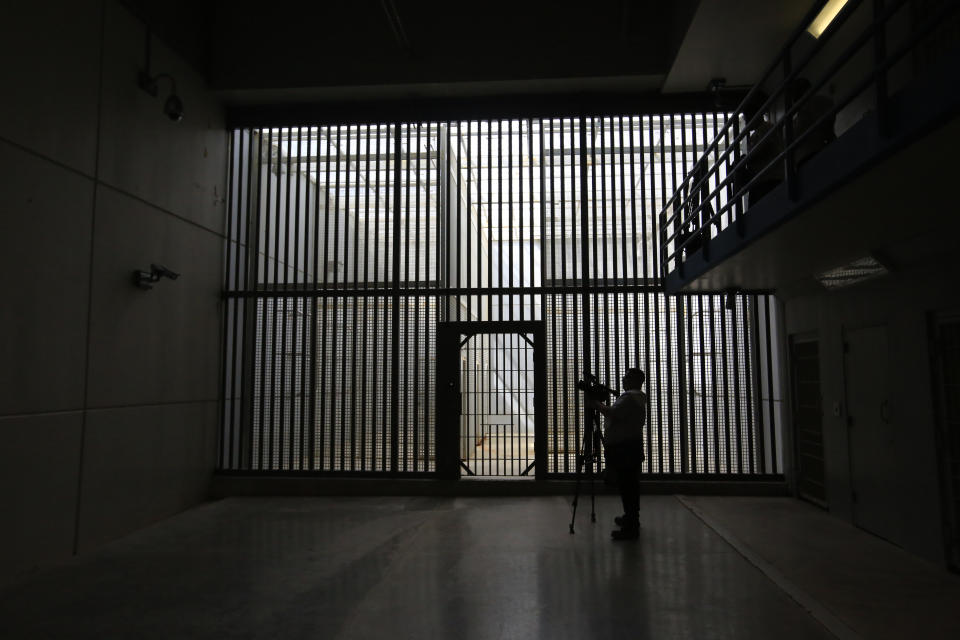 A journalist films the now closed Laguna del Toro maximum security facility during a media tour of the former Islas Marias penal colony located off Mexico's Pacific coast, Saturday, March 16, 2019. Bars and cells were limited to the maximum security facility because the surrounding ocean effectively prevented escape. (AP Photo/Rebecca Blackwell)