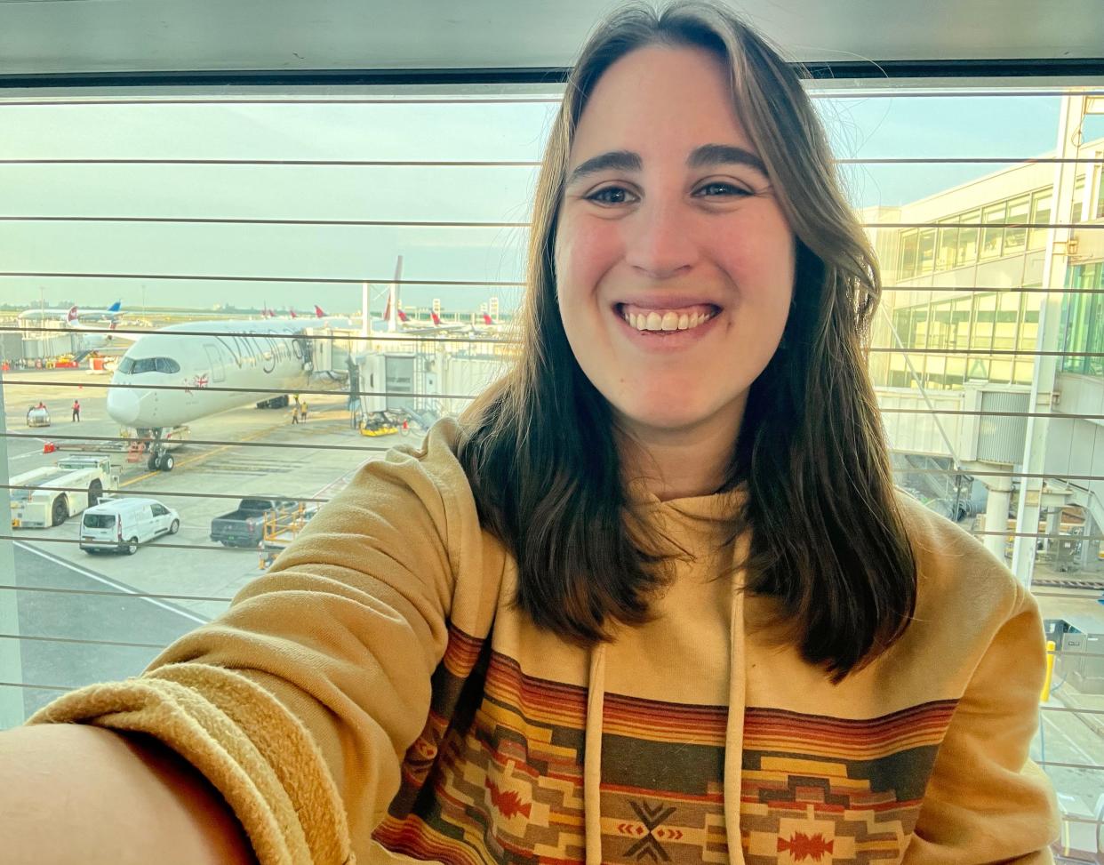 A selfie of the author in front of Virgin plane at the gate.