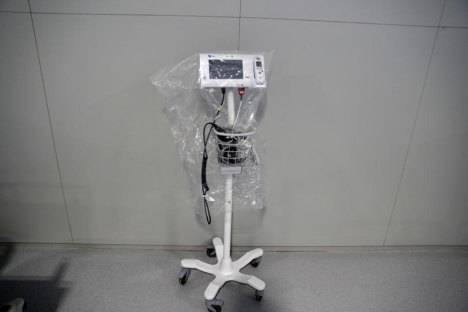 An apparatus sits covered with plastic in the empty Isabel Zendal new hospital during the official opening in Madrid, Spain, Tuesday, Dec. 1, 2020. Authorities in Madrid are holding a ceremony to open part of a 1,000-bed hospital for emergencies that critics say is no more than a vanity project, a building with beds not ready to receive patients and unnecessary now that contagion and hospitalizations are waning. Spain has officially logged 1.6 million infections and over 45,000 deaths confirmed for COVID-19 since the beginning of the year. (AP Photo/Paul White)