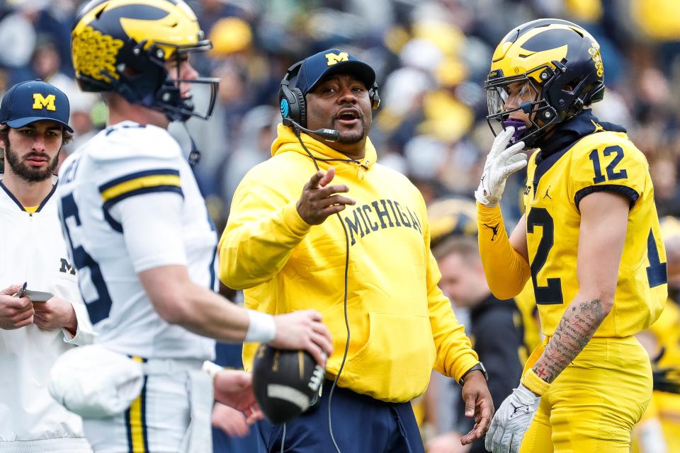 Michigan offensive pass game coordinator and wide receivers coach Ron Bellamy talks to quarterback Davis Warren (16) during the second half of the spring game at Michigan Stadium in Ann Arbor on Saturday, April 20, 2024.