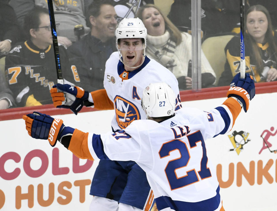 New York Islanders left wing Anders Lee (27) celebrates his overtime goal with center Brock Nelson as they defeated the Pittsburgh Penguins 4-3 in an NHL hockey game, Thursday, March 9, 2023, in Pittsburgh. (AP Photo/Philip G. Pavely)