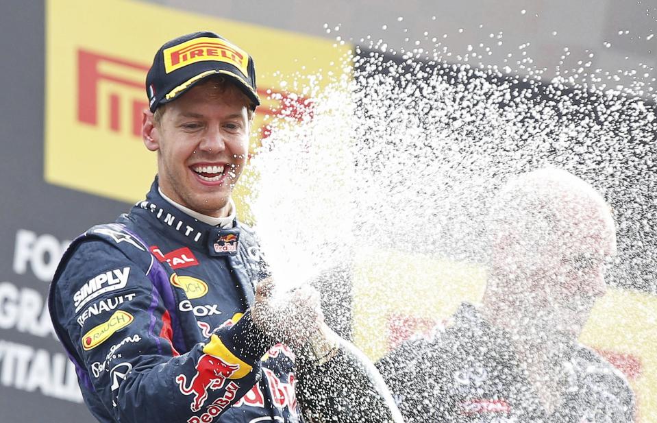 Red Bull Formula One driver Sebastian Vettel of Germany sprays champagne on the podium after winning the Italian F1 Grand Prix at the Monza circuit September 8, 2013. Vettel won the Italian Grand Prix at a canter on Sunday, leading from pole position to celebrate his 32nd career win and third at Monza. REUTERS/Stefano Rellandini (ITALY - Tags: SPORT MOTORSPORT F1 TPX IMAGES OF THE DAY)