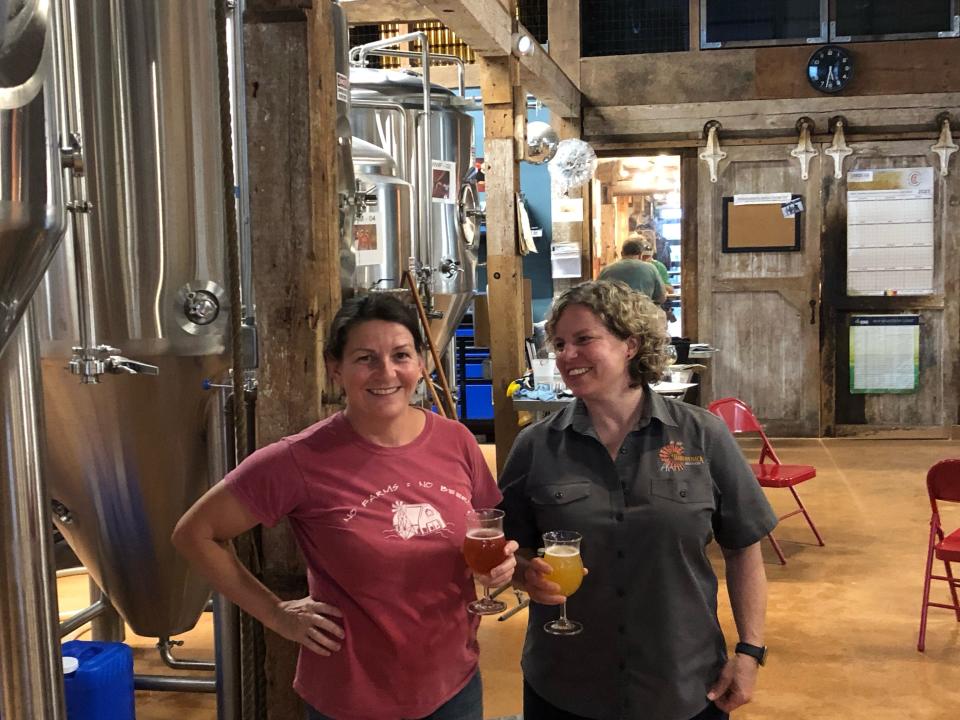Throwback Brewery founders Annette Lee, left, and Nicole Carrier, right, share a laugh, and a beer, in the tap room. To commemorate their 10th anniversary, Throwback has released four commemorative beers this summer that help tell the story of this unique and popular North Hampton brewery.