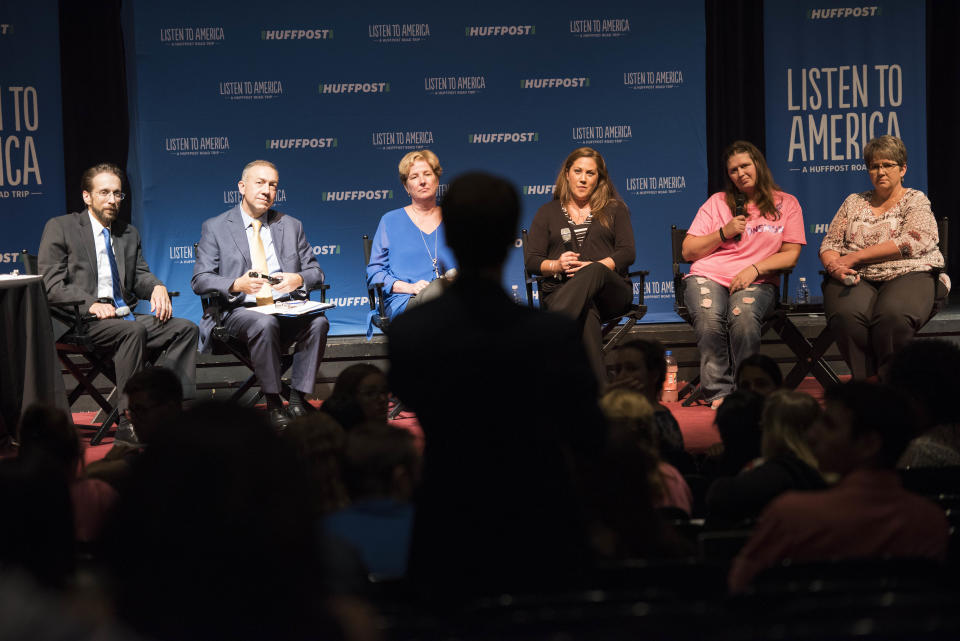 An audience member asks host Rob Byers (far left) and panelists Mike Brumage, Andrea Darr, Amanda Dietz, Brandi Gunnoe and Lois Vance a question during the "Surviving the Opioid Crisis" forum at the Little Theater at the Charleston Civic Center.