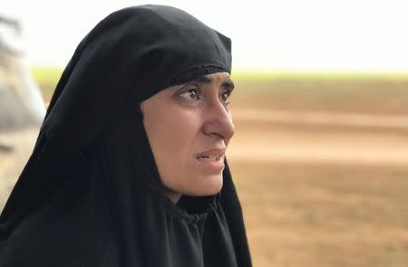 Yazidi woman Salwa Sayed al-Omar, who escaped from the Islamic State, talks during an interview with Reuters near the village of Baghouz, Deir Al Zor province, in Syria March 7, 2019. Picture taken March 7, 2019. REUTERS/STRINGER