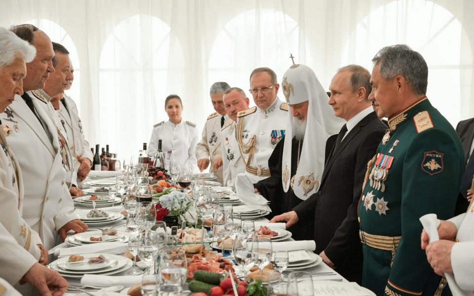 Defence minister Sergei Shoigu, president Vladimir Putin, and Patriarch Kirill of Moscow and all Russia at a Navy Day reception  - Credit: Alexei Nikolsky\\TASS via Getty Images