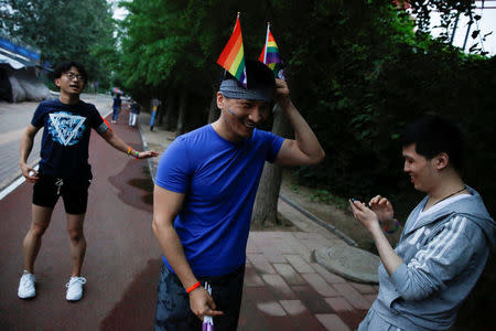 Participants get ready for a 5.17 km run to mark International Day Against Homophobia in a park in Beijing, China, May 17, 2018. REUTERS/Thomas Peter