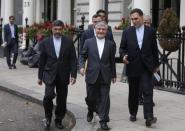 Irain's Deputy Foreign Minister, Mehdi Danesh Yazdi (C) walks with Iran's charge d'affaires to the Iranian Embassy in London, Mohammad Hassan Habibollahzadeh (R), to his residency in London, Britain August 23, 2015. REUTERS/Peter Nicholls