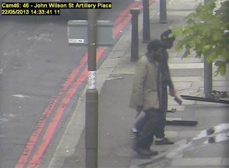 Michael Adebowale (L) and Michael Adebolajo walk back to the south footpath of Artillery Place in Woolwich in this handout still image taken from May 22, 2013 CCTV footage by the Metropolitan Police, that was shown to the jury during the Lee Rigby murder trial at the Old Bailey in London December 3, 2013. REUTERS/Metropolitan Police/Handout via Reuters