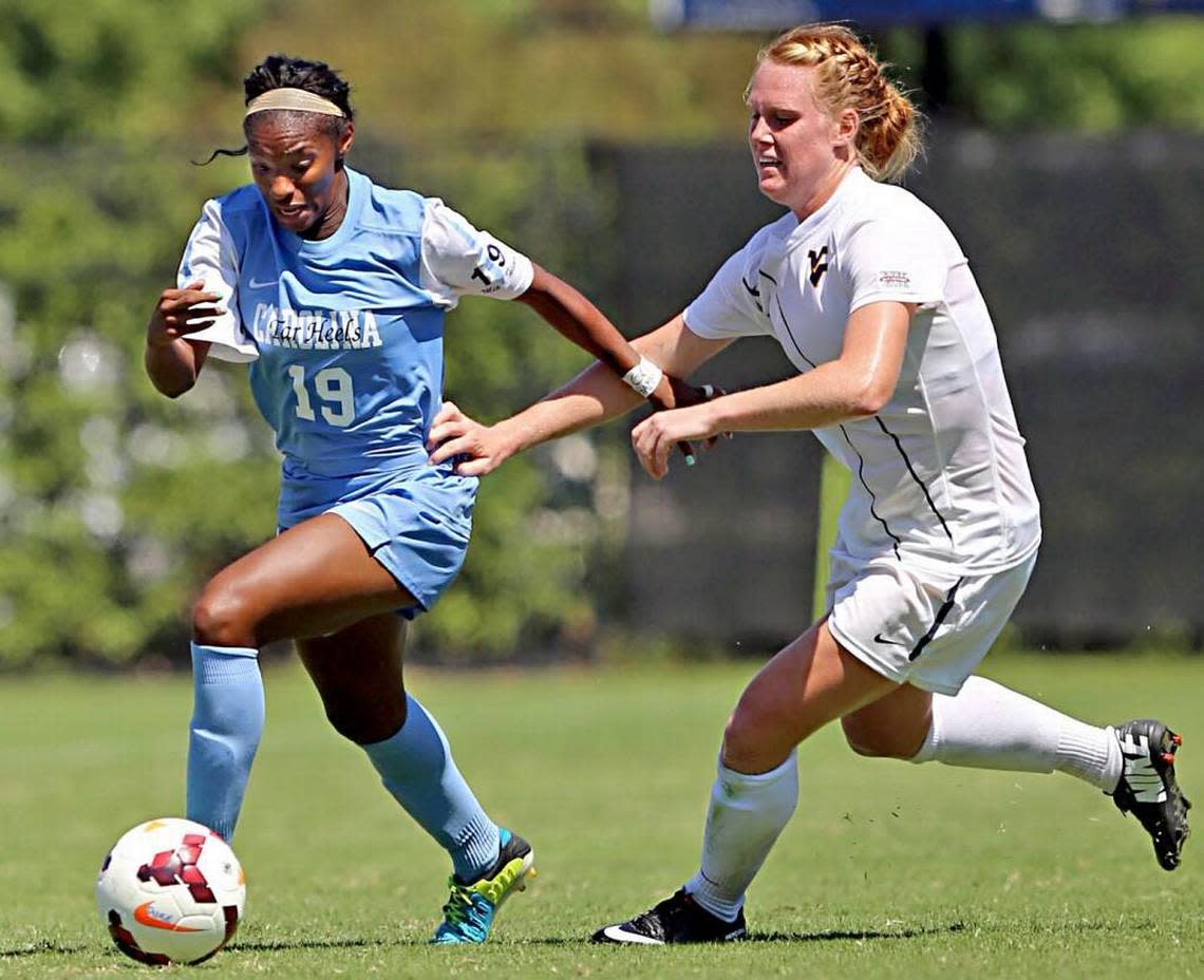 UNC’s Crystal Dunn beats West Virginia’s Leah Emaus to the ball in the second period during the Duke Nike Classic women’s soccer tournament at Koskinen Stadium in Durham, N.C. on Sunday, September 8, 2013. Al Drago