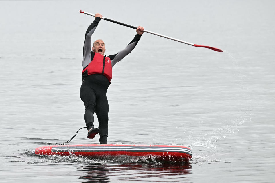 Britain's Liberal Democrat party Leader Ed Davey falls from a paddle board, during a Liberal Democrat general election campaign, at Lake Windermere, in north west England, on May 28, 2024.