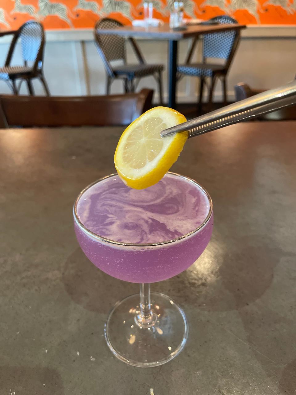 Moms can enjoy a 'Same But Different' cocktail, which features vodka, lemon juice, lavender simple syrup, Butterfly pea powder. prosecco and is garnished with a lemon wheel, on the house for Mother's Day at Almond in Palm Beach.