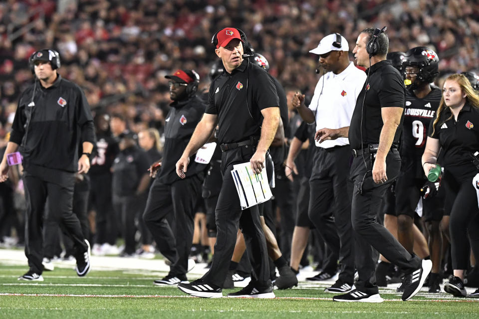 Louisville coach Jeff Brohm heads onto the field during the first half of the team's NCAA college football game against Murray State in Louisville, Ky., Thursday, Sept. 7, 2023. (AP Photo/Timothy D. Easley)