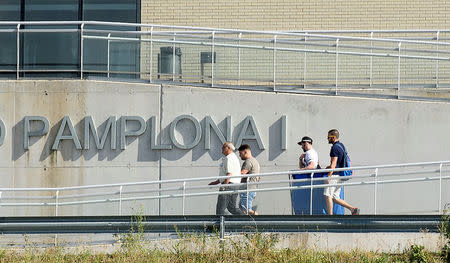 Three of the five men cleared of gang rape of a teenager and convicted of a lesser crime of sexual abuse walk with an unidentified man as they leave jail after being granted provisional release in Pamplona, Spain, June 22, 2018. REUTERS/Pablo Lasaosa