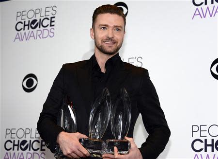 Justin Timberlake holds the awards he won for favorite album and favorite male artist at the 2014 People's Choice Awards in Los Angeles, California January 8, 2014. REUTERS/Kevork Djansezian