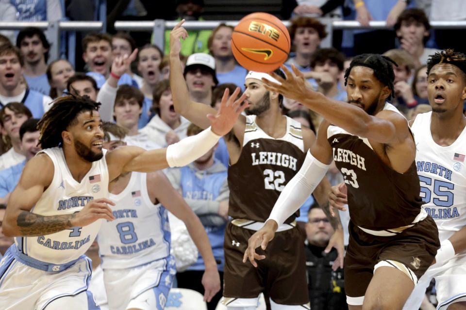 North Carolina guard RJ Davis (4) and Lehigh forward Bube Momah (23) vie for a loose ball during the first half of an NCAA college basketball game Sunday, Nov. 12, 2023, in Chapel Hill, N.C. (AP Photo/Chris Seward)