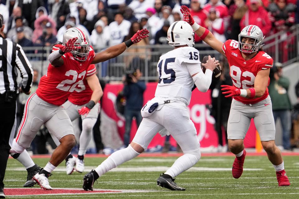 Oct 21, 2023; Columbus, Ohio, USA; Ohio State Buckeyes linebacker Steele Chambers (22) and defensive end Caden Curry (92) pressure Penn State Nittany Lions quarterback Drew Allar (15) during the second half of the NCAA football game at Ohio Stadium. Ohio State won 20-12.