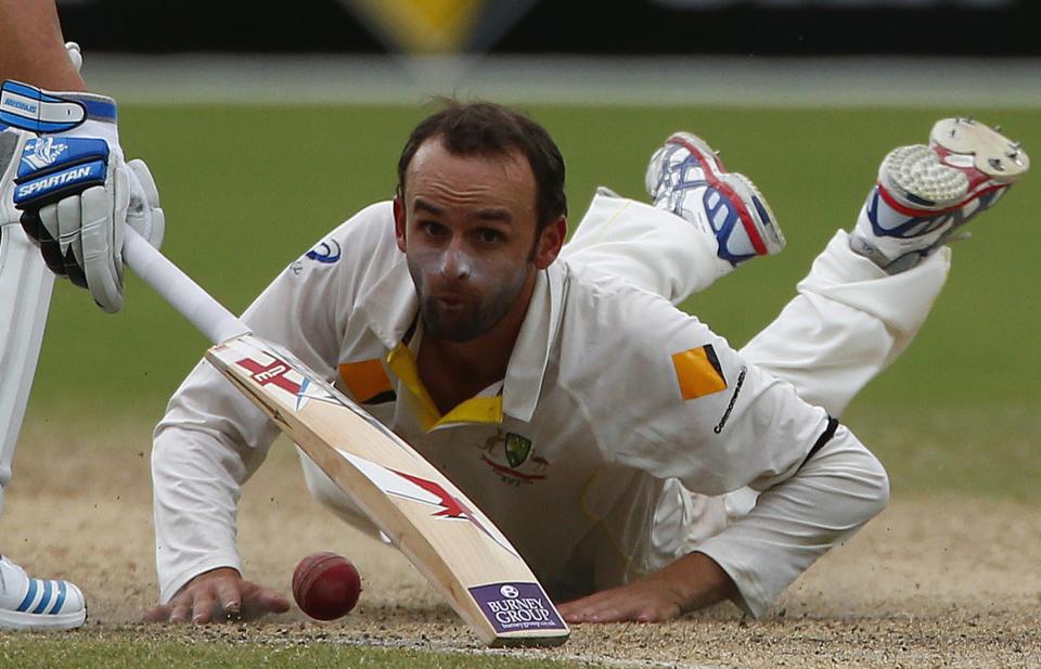 Australia's Nathan Lyon looks at the ball after a miss fielding hit by England's Ben Stokes during the fourth day's play in the second Ashes cricket test at the Adelaide Oval December 8, 2013.REUTERS/David Gray (AUSTRALIA - Tags: SPORT CRICKET)