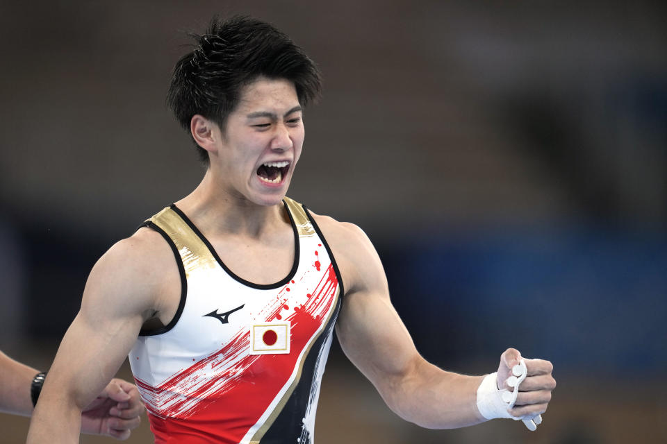 Daiki Hashimoto, of Japan, celebrates his performance on the horizontal bar during the artistic men's team final at the 2020 Summer Olympics, Monday, July 26, 2021, in Tokyo. (AP Photo/Natacha Pisarenko)