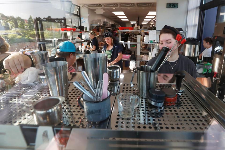 The staff busy at work during the grand opening of Cafe Racer in Athens, Ga., on Tuesday, Aug 22, 2023.