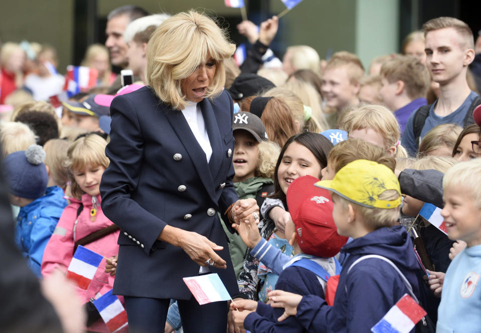 Brigitte Macron wife of French President Emmanuel Macron meets children with Jenni Haukio, wife of President of Finland Sauli Niinisto, at the New Children's Hospital in Helsinki, Finland, Thursday Aug. 30, 2018. President Macron is in Finland on a two-day official visit. (Onni Okala/Lehtikuva via AP)