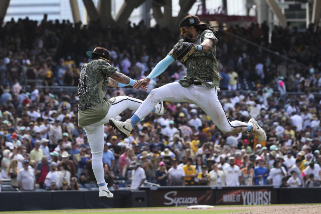 San Diego Padres' Rougned Odor talks to teammates in the dugout