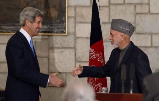 US Secretary of State John Kerry (L) and Afghanistan's President Hamid Karzai shake hands at the end of their press conference at the Presidential Palace in Kabul on March 25, 2013. Kerry made an unannounced visit to Kabul on Monday and vowed to stick by Afghanistan despite Karzai's hostility to US-led military efforts in the country