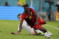 Italy's Nicolo Barella, rear, and Belgium's Jeremy Doku challenge for the ball during the Euro 2020 soccer championship quarterfinal match between Belgium and Italy at the Allianz Arena stadium in Munich, Germany, Friday, July 2, 2021. (AP Photo/Matthias Schrader, Pool)