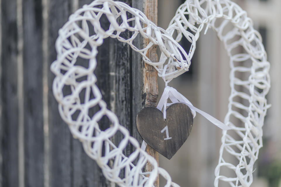 White rattan heart decoration with the number one on a heart-shaped piece of wood
