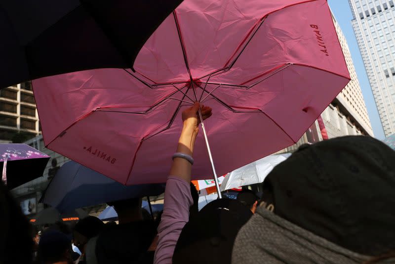 An anti-government protester opens an umbrella during the "Lest We Forget" rally in Hong Kong