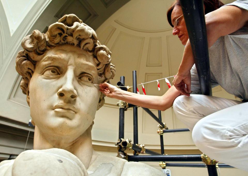 Italian restorer Cinzia Parnigoni works on cleaning one of the world's most famous statues in the world in 2003 at the Galleria del'Academia in Florence where the statue has been kept since 1873. The statue stands some 14 feet high.