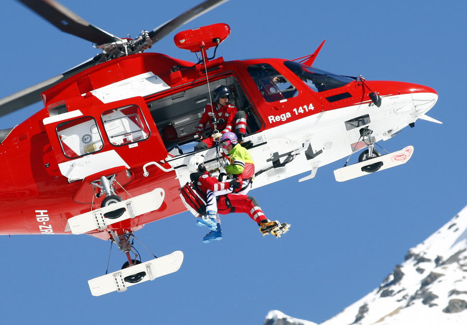 Germany's Maria Hoefl Riesch is lifted to a rescue helicopter after crashing during a women's alpine skiing downhill at the World Cup finals in Lenzerheide, Switzerland, Wednesday, March 12, 2013. (AP Photo/Marco Trovati)