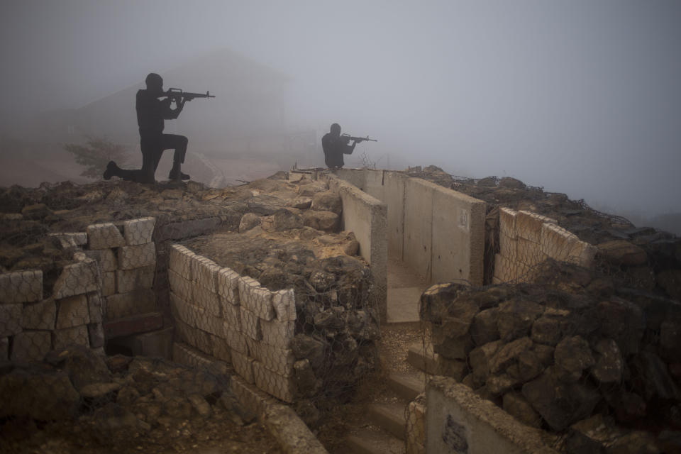 FILE - In this August 2014, file photo, metal boards in the shape of gunmen sit on an old bunker at an observation point on Mount Bental in the Israeli controlled Golan Heights, overlooking the border with Syria. The Golan front has been mostly quiet since 1974, a year after Syria and Israel fought a war during which Damascus unsuccessfully tried to retake the plateau. (AP Photo/Ariel Schalit, File)