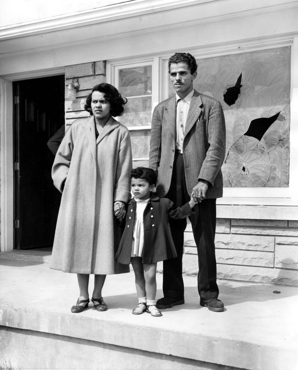 The Wade family stands before a broken window in May 1954. Andrew and Charlotte Wade faced racial violence after a white couple, Anne and Carl Braden, purchased a home for them in a white neighborhood.