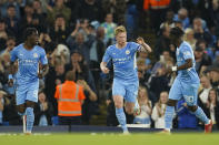 Manchester City's Kevin De Bruyne, centre, celebrates with teammate's Romeo Lavia, right, and Joshua Wilson-Esbrand after scoring his team's first goal during the English League Cup third round soccer match between Manchester City and Wycombe Wanderers at Etihad Stadium, in Manchester England, Tuesday, Sept. 21, 2021. (AP Photo/Dave Thompson)