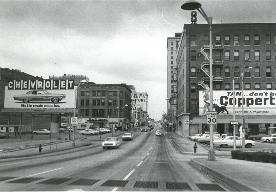 With headlights on, cars navigate the streets of downtown Jacksonville during the solar eclipse on March 7, 1970.