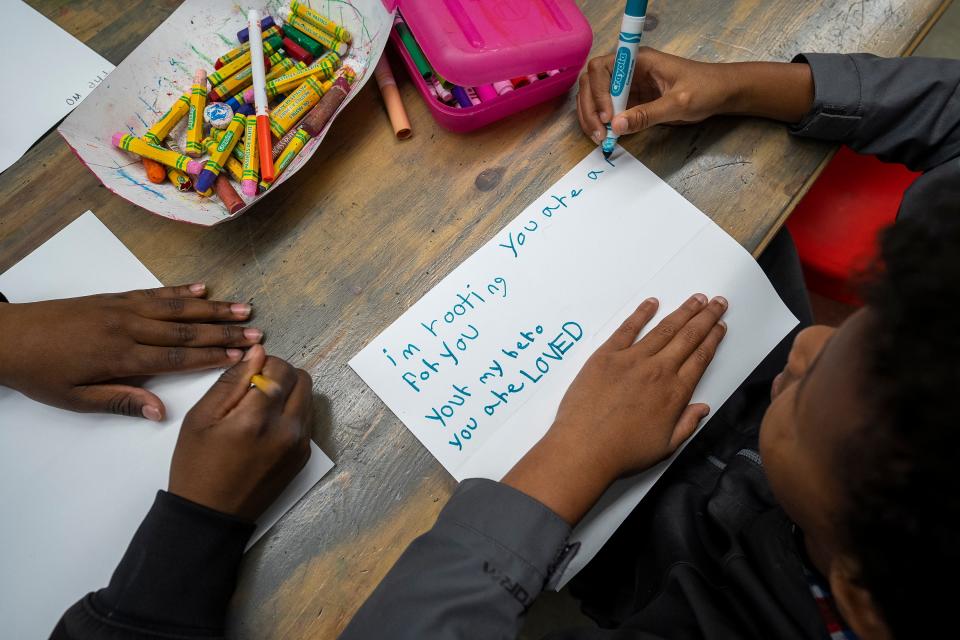 Tai Brown, 9, works on his card of hope and support during his third-grade class at Columbus City's Devonshire Elementary School, where his teacher, Morgan Chase, is a breast cancer survivor.