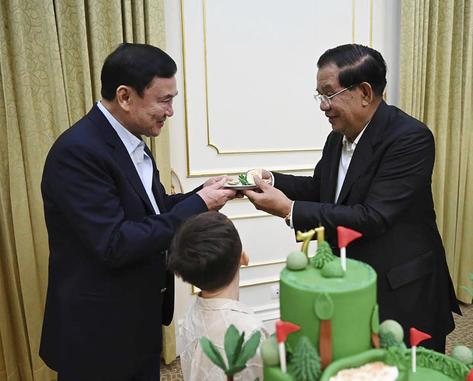 In this photo provided by Cambodia's Prime Minister Telegram, Cambodian Prime Minister Hun Sen, right, gives a souvenir to former Thai Prime Minister Thaksin Shinawatra during a meeting at Peace Palace in Phnom Penh, Cambodia, Saturday, Aug. 5, 2023. Thaksin attended a birthday party for outgoing Cambodian Prime Minister Hun Sen in Phnom Penh, according to video posted online Sunday, Aug. 6, a day after Thaksin said he would delay plans to return to Thailand following years of self-imposed exile. (Cambodia's Prime Minister Telegram via AP)