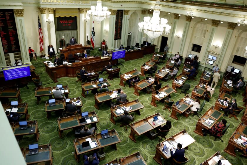 FILE - In this May 26, 2020, file photo, members of the state Assembly meet at the Capitol in Sacramento, Calif. On Thursday, July 15, 2021, California lawmakers are scheduled to vote on a bill that would fund guaranteed income programs across the state. Guaranteed income programs give money to people each month with no restrictions on how they can spend it. (AP Photo/Rich Pedroncelli, Pool, File)