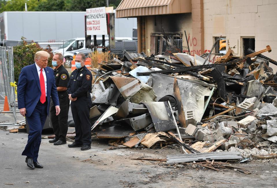 President Donald Trump tours an area affected by civil unrest in Kenosha, Wisconsin on September 1, 2020.