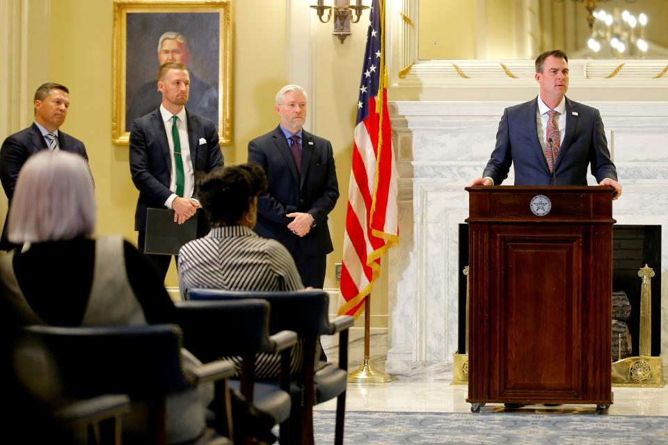 Gov. Kevin Stitt speaks at a press conference inside the state Capitol in Oklahoma City on Tuesday. Stitt announced an executive order allowing state employees to substitute in schools. From left, State Chamber CEO Chad Warmington, Education Secretary Ryan Walters and state Chief Operating Officer Steven Harpe listen.