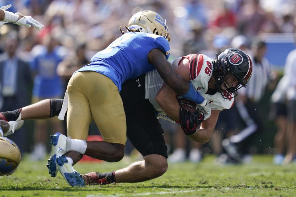 Utah tight end Dalton Kincaid is tackled by UCLA defensive back Mo Osling III.